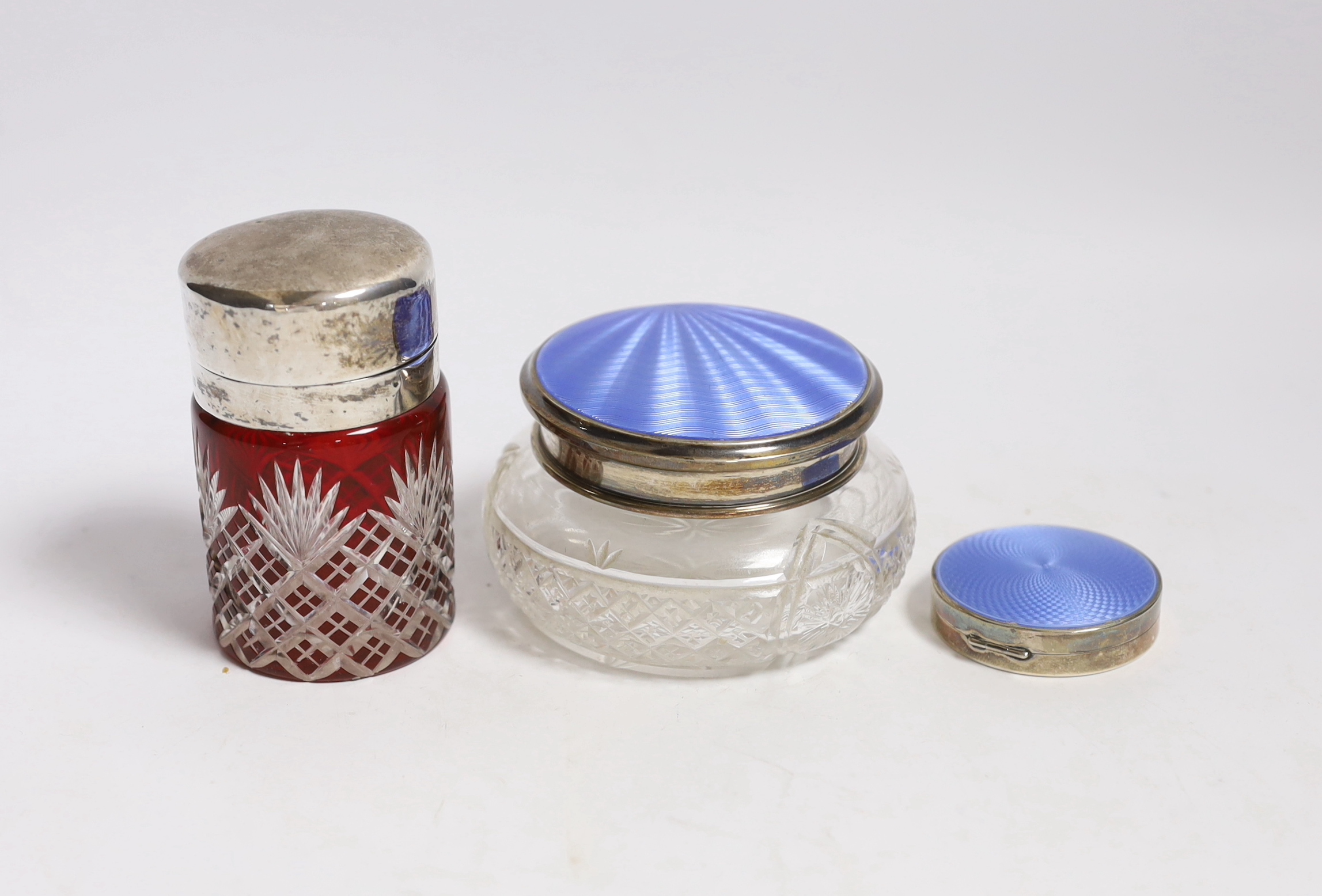 A silver and enamel compact, a silver and enamel mounted glass jar and an Edwardian silver mounted cut glass salts jar by William Hutton & Sons, Birmingham, 1904, 85mm.